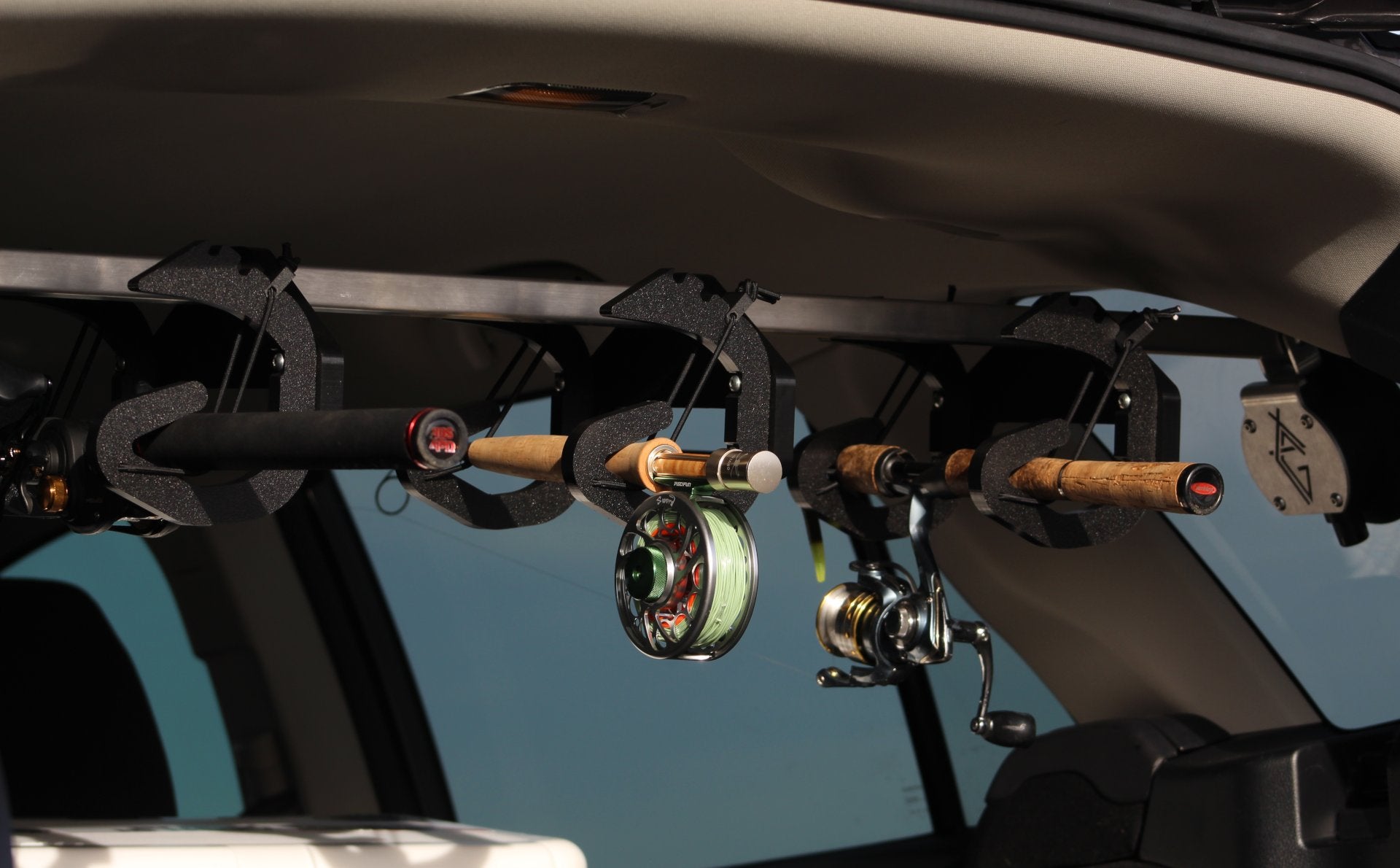 Rod Rig holding a fly rod and a spinning reel rod. In-vehicle fishing rod carrier.
